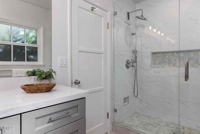 bathroom with a stall shower and vanity