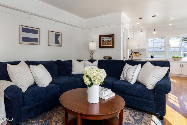 living room with recessed lighting, light wood-type flooring, and crown molding