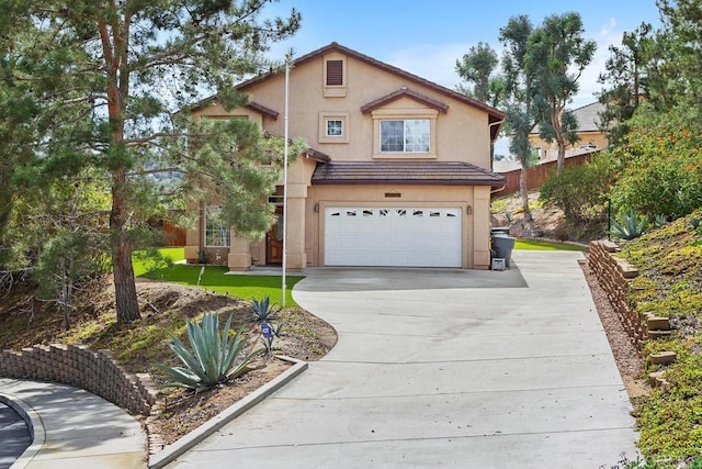 traditional-style home featuring an attached garage, a tiled roof, concrete driveway, and stucco siding