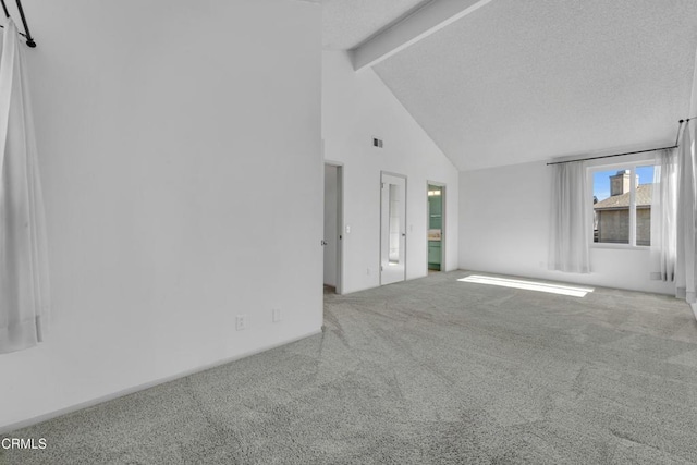 spare room featuring high vaulted ceiling, carpet, beam ceiling, and visible vents