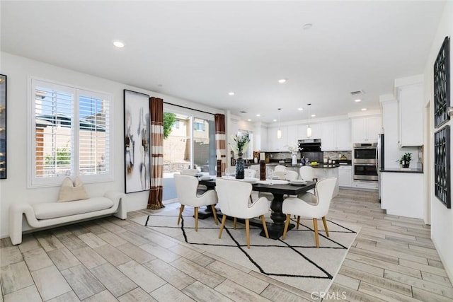 dining room featuring wood tiled floor and recessed lighting