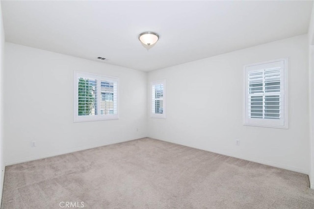 carpeted spare room with visible vents