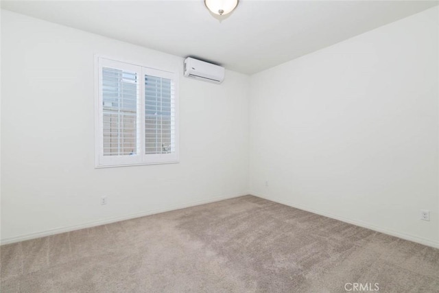 empty room featuring a wall mounted AC, carpet, and baseboards