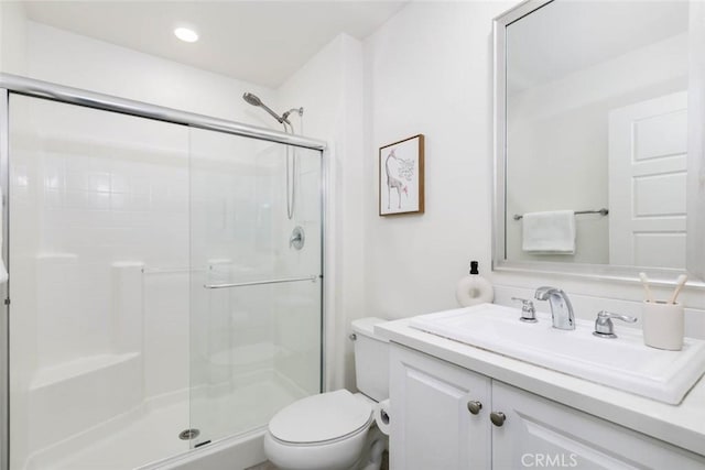 full bath featuring recessed lighting, a shower stall, toilet, and vanity