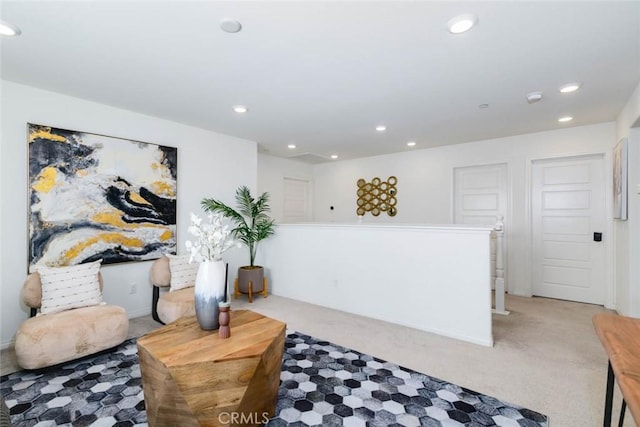 sitting room featuring recessed lighting and light colored carpet