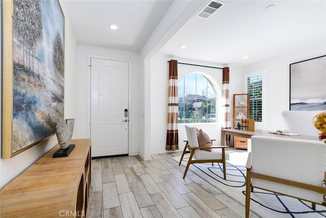 foyer entrance with light wood-type flooring, visible vents, and recessed lighting