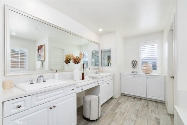 full bathroom featuring recessed lighting, vanity, and wood finished floors