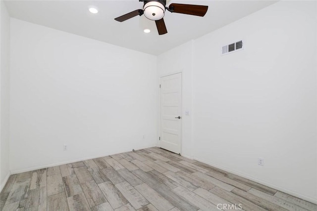 spare room with a ceiling fan, recessed lighting, visible vents, and wood finished floors