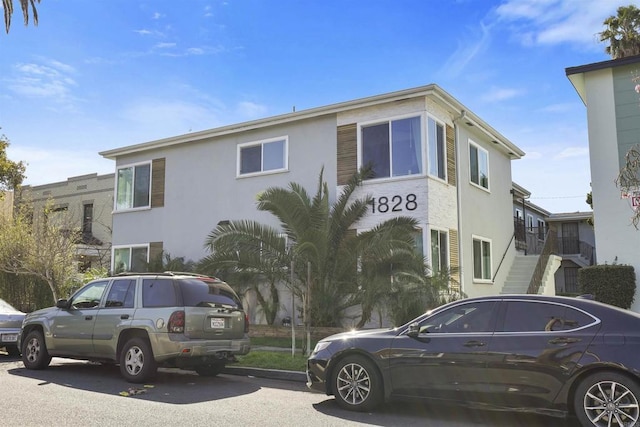 exterior space with stairs and stucco siding