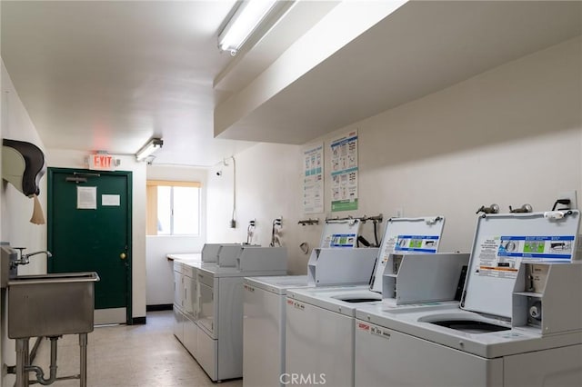 community laundry room with washing machine and dryer and a sink