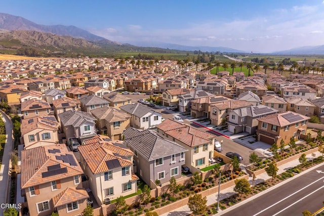 birds eye view of property with a mountain view and a residential view