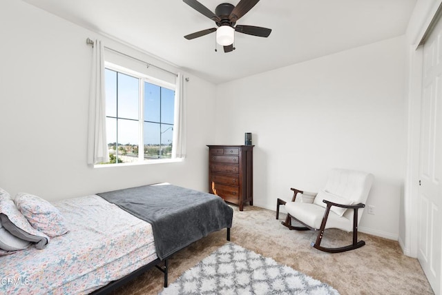 bedroom with ceiling fan, a closet, carpet flooring, and baseboards