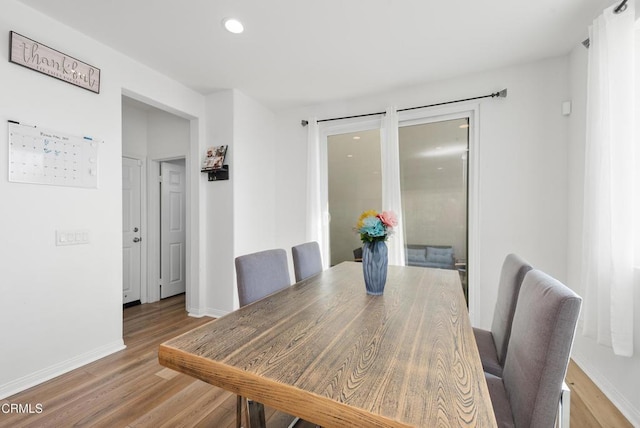 dining room featuring recessed lighting, baseboards, and wood finished floors