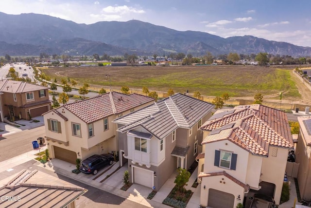 drone / aerial view featuring a residential view and a mountain view