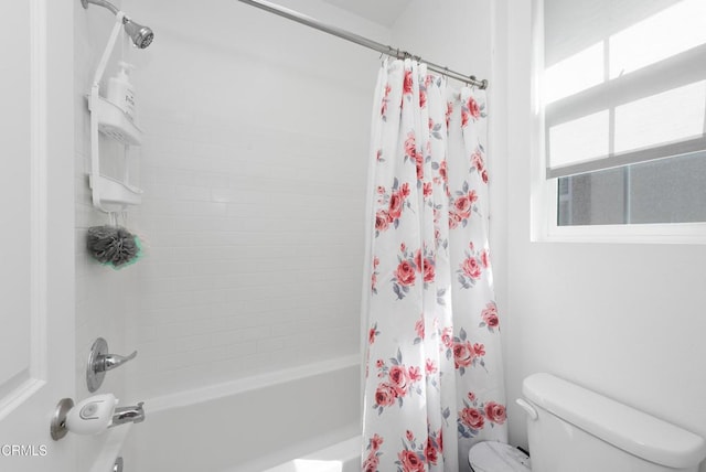 bathroom featuring toilet and shower / bath combo