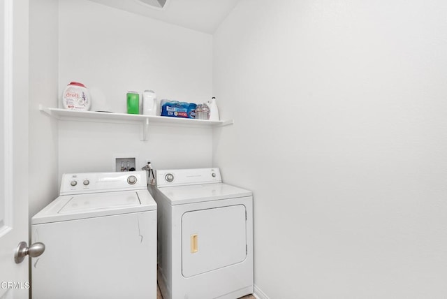 clothes washing area featuring laundry area and washing machine and clothes dryer