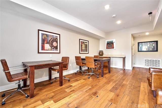 home office featuring light wood-type flooring, visible vents, baseboards, and recessed lighting