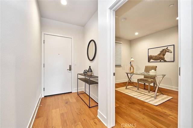 interior space with light wood finished floors, baseboards, and recessed lighting