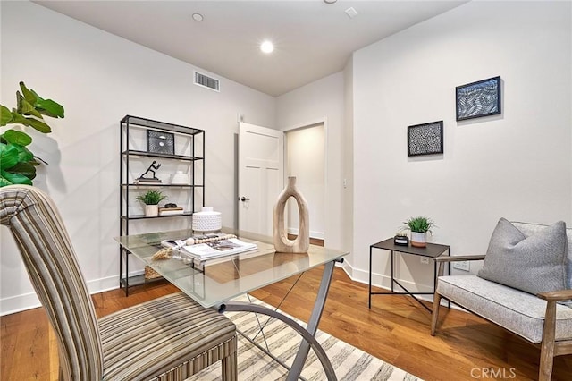 office space featuring visible vents, baseboards, wood finished floors, and recessed lighting