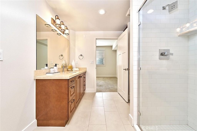 bathroom with tile patterned flooring, a sink, baseboards, double vanity, and a stall shower