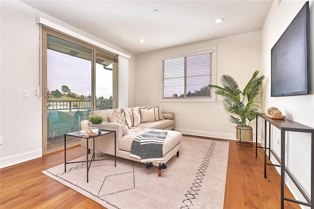 sitting room with recessed lighting, baseboards, and wood finished floors