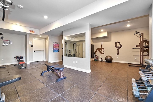 exercise room with recessed lighting and baseboards