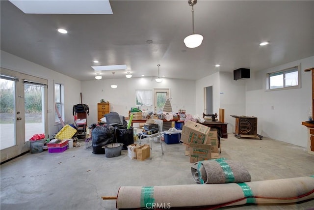 misc room featuring lofted ceiling, unfinished concrete floors, and recessed lighting