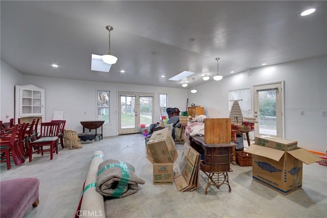 misc room with lofted ceiling with skylight, recessed lighting, and french doors