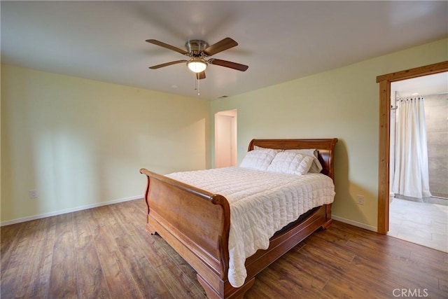 bedroom featuring ceiling fan, baseboards, and wood finished floors