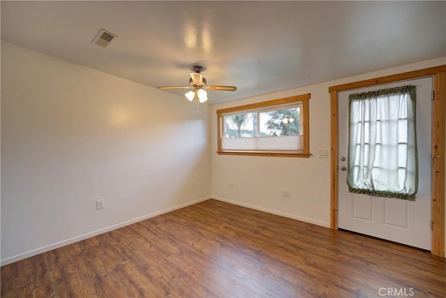 entrance foyer with visible vents, baseboards, ceiling fan, and wood finished floors