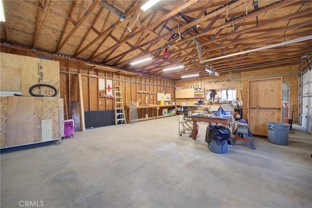 garage featuring a garage door opener and a workshop area