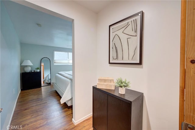 bedroom with wood finished floors and baseboards