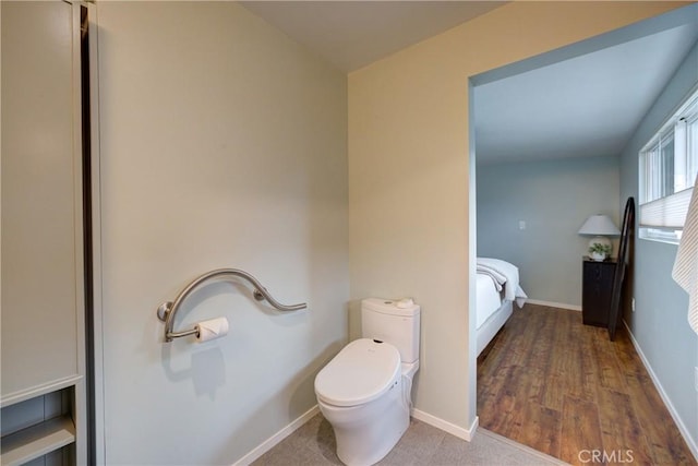 bathroom with baseboards and toilet