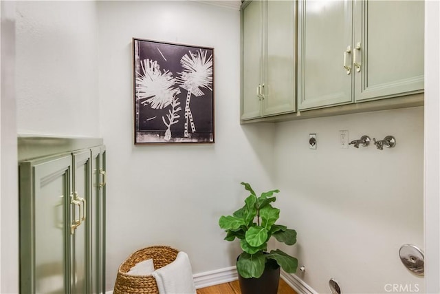 laundry area with washer hookup, cabinet space, electric dryer hookup, and baseboards