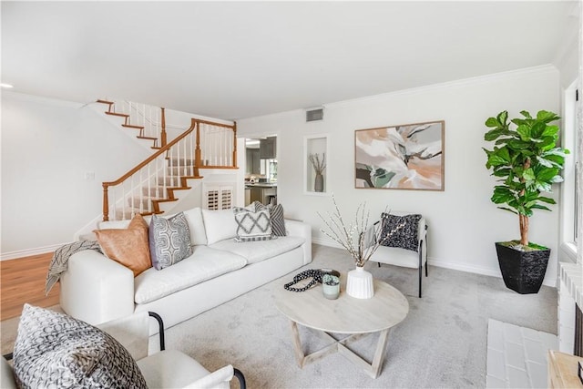 living area with stairs, crown molding, visible vents, and baseboards