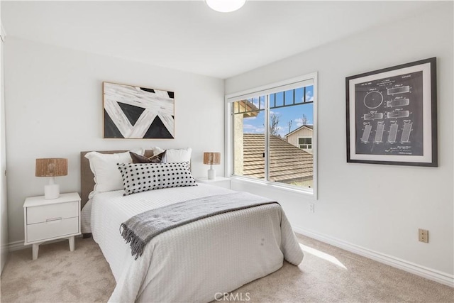 carpeted bedroom with baseboards