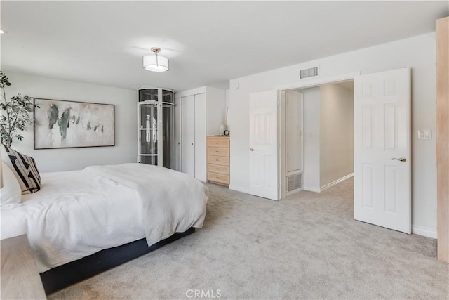 bedroom featuring baseboards, a closet, visible vents, and light colored carpet