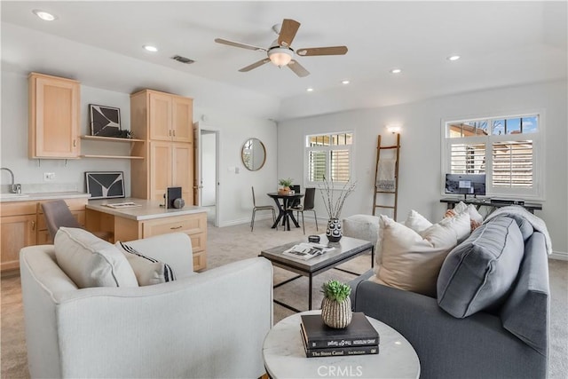 living room featuring light carpet, baseboards, visible vents, a ceiling fan, and recessed lighting