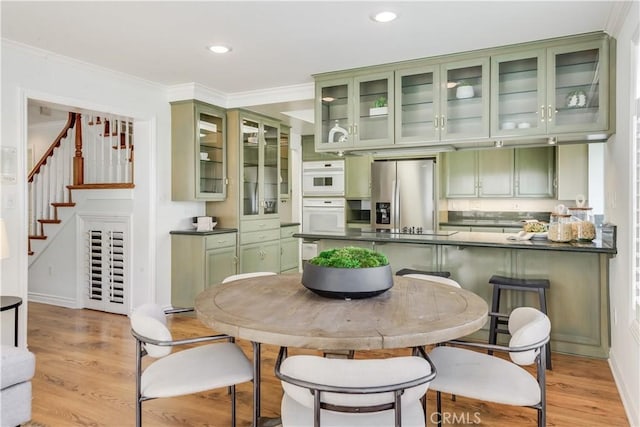 dining room with stairs, ornamental molding, recessed lighting, and light wood-style floors