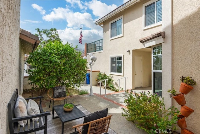 exterior space with a patio and stucco siding