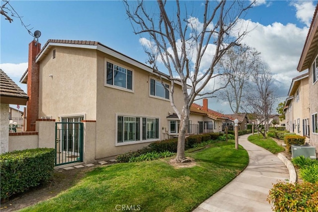 surrounding community with a gate, a lawn, and fence