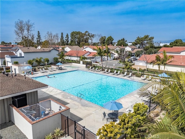 pool featuring a residential view, fence, and a patio