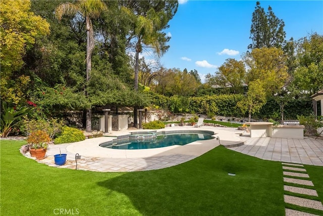 pool featuring a patio area and a yard