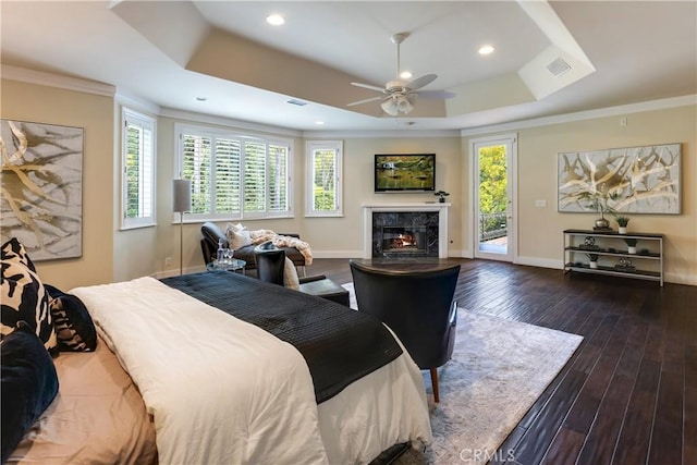 bedroom featuring dark wood-style floors, a raised ceiling, visible vents, access to outside, and baseboards