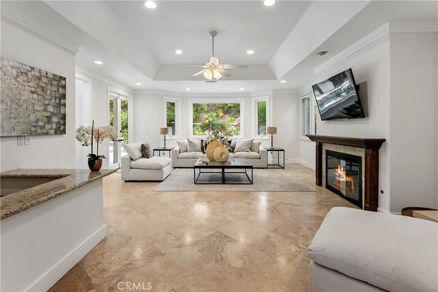 25605 Queenscliff Ct, Calabasas, CA 91302 - living area with ceiling fan, recessed lighting, a glass covered fireplace, a raised ceiling, and crown molding
