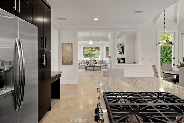 kitchen featuring light stone countertops, a ceiling fan, visible vents, and stainless steel fridge with ice dispenser