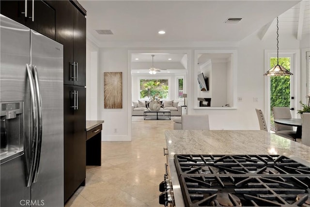 25605 Queenscliff Ct, Calabasas, CA 91302 - kitchen with stainless steel refrigerator with ice dispenser, a ceiling fan, light stone counters, dark cabinets, and cooktop