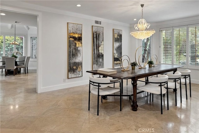 dining room with plenty of natural light, visible vents, crown molding, and a notable chandelier