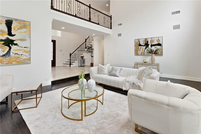 25605 Queenscliff Ct, Calabasas, CA 91302 - living area with stairs, a towering ceiling, dark wood-style floors, and recessed lighting
