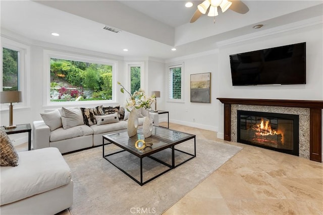 living room with a premium fireplace, a ceiling fan, visible vents, and recessed lighting